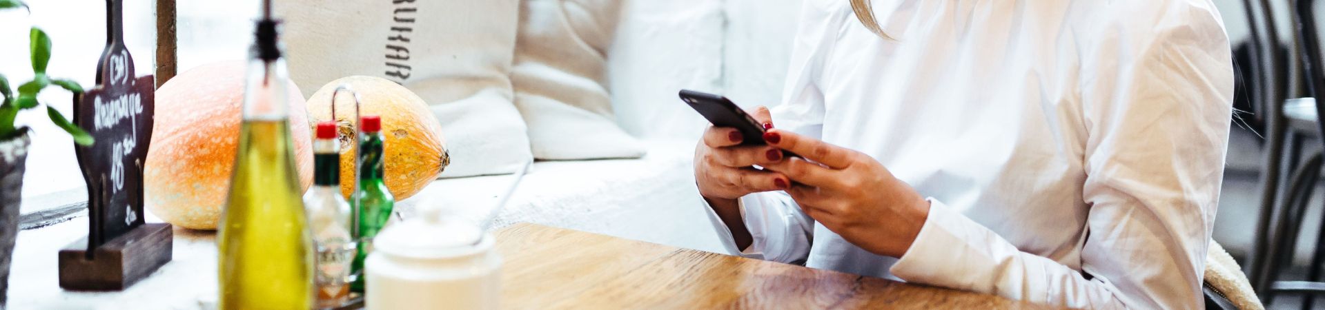 Vrouw bestelt met telefoon in een restaurant